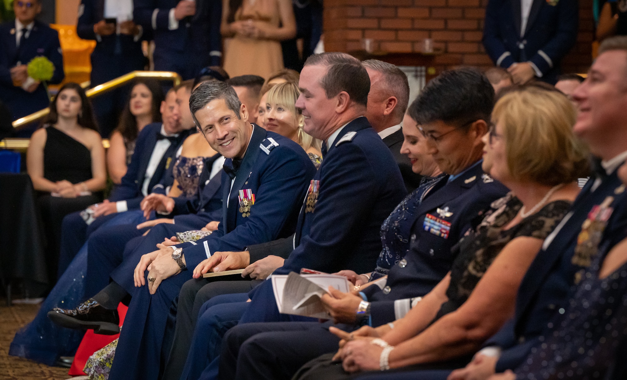 U.S. Air Force Col. William McKibban, 51st Fighter Wing commander, smiles while seated amongst distinguished guests during the 76th Air Force Ball at U.S. Army Garrison Yongsan, Republic of Korea, Sept. 23, 2023. The ball commemorated the 76th anniversary of the U.S. Air Force and the legacy of its members, who continue to dedicate time and service to inspire future generations. (U.S. Air Force photo by Staff Sgt. Kelsea Caballero)