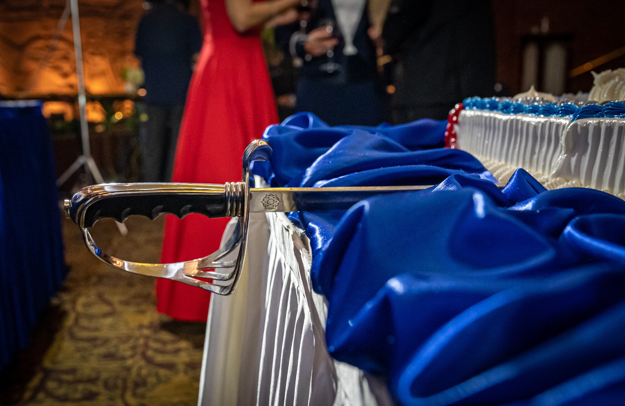A ceremonial sword used to slice a birthday cake at the 76th Air Force Ball lays on a table, at U.S. Army Garrison Yongsan, Republic of Korea, Sept. 23, 2023. It is customary for the most senior and junior Airmen to cut the cake which represents the heritage between generations. (U.S. Air Force photo by Staff Sgt. Kelsea Caballero)