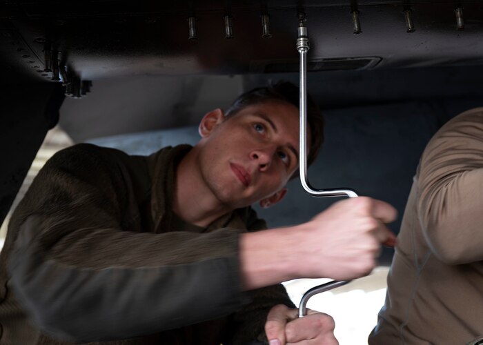 A maintainer works on an aircraft