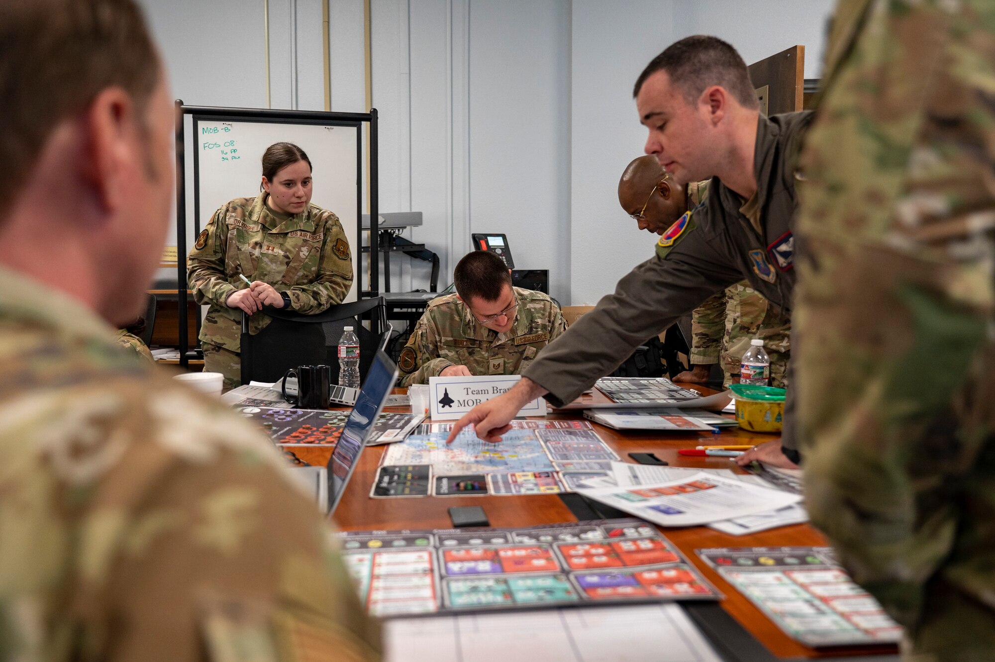 Leadership assigned to Dyess Air Force Base, Texas, discuss plans during a table-top exercise.