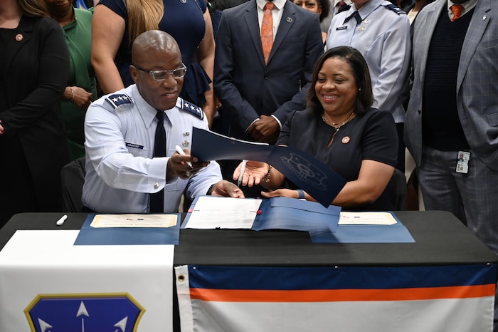 U.S. Air Force Lt. Gen. Stacey T. Hawkins, Air Force Sustainment Center commander, and Dr. Ruth Ray Jackson, Langston University interim president sign official documents establishing an educational partnership agreement between the two entities.