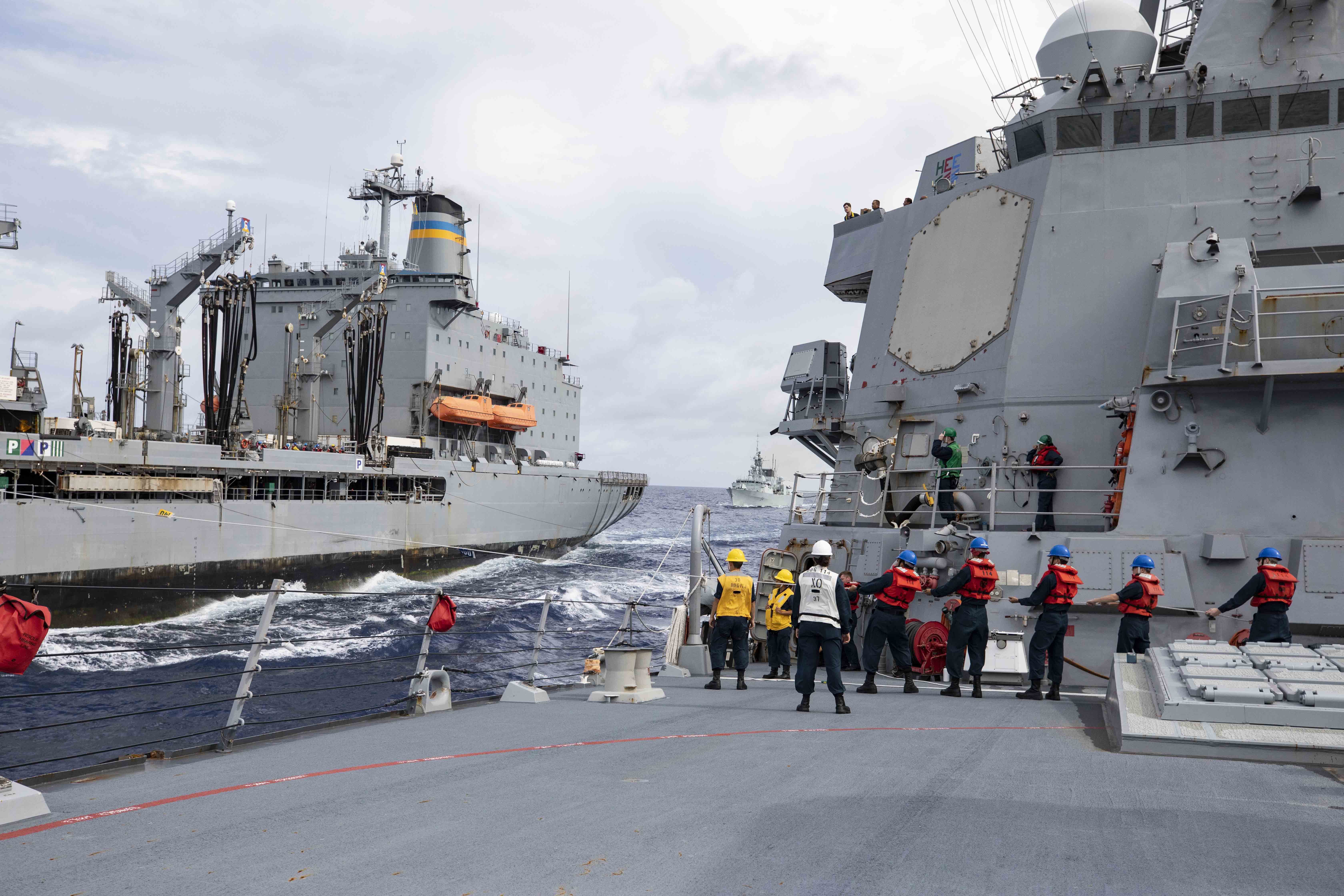 USS Ralph Johnson (DDG 114) and HMCS Ottawa (FFH 341) replenish from USNS Yukon (T-AO 202) in the South China Sea.