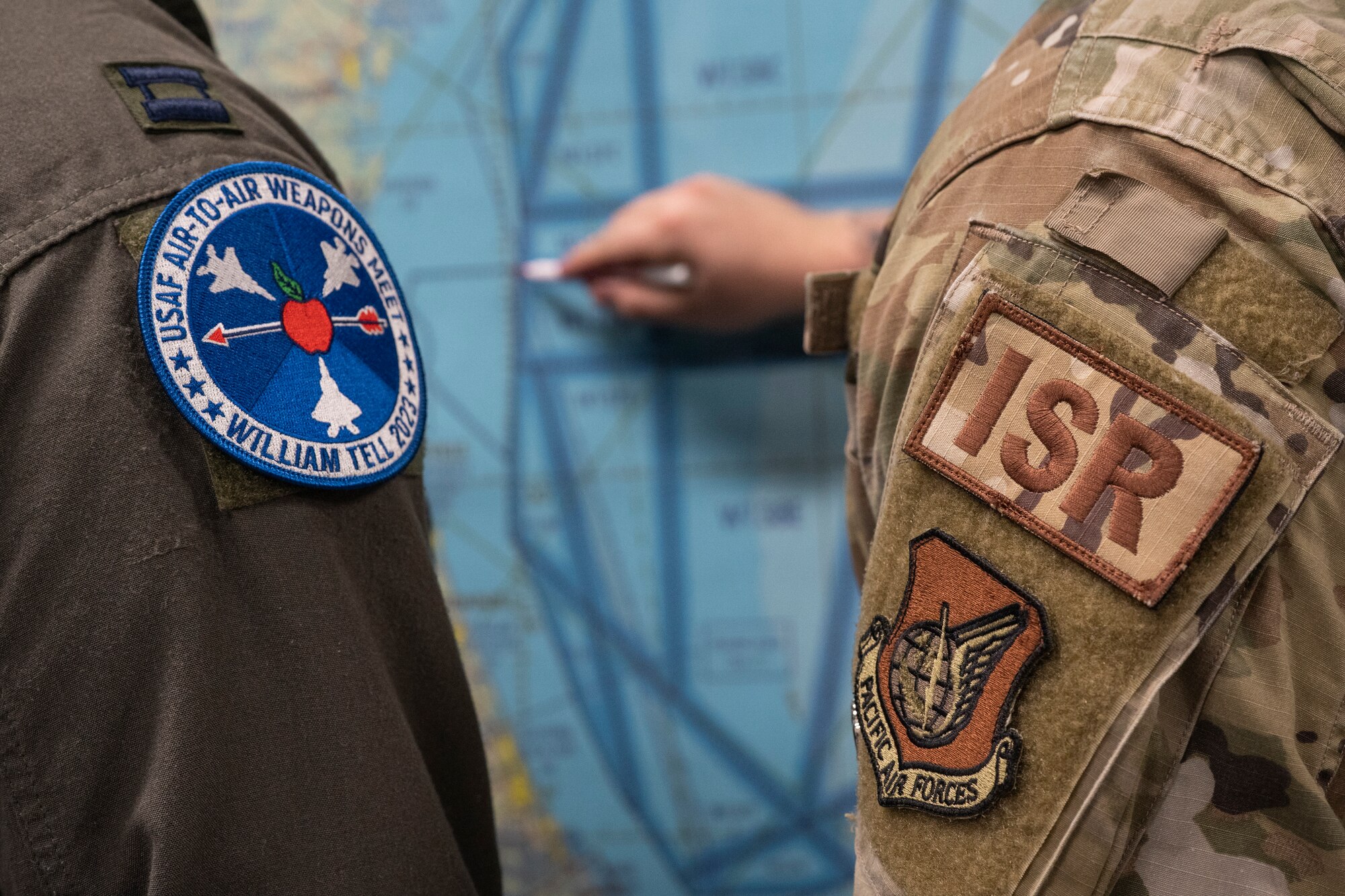 Two Airmen look at a map of the coast of Georgia.