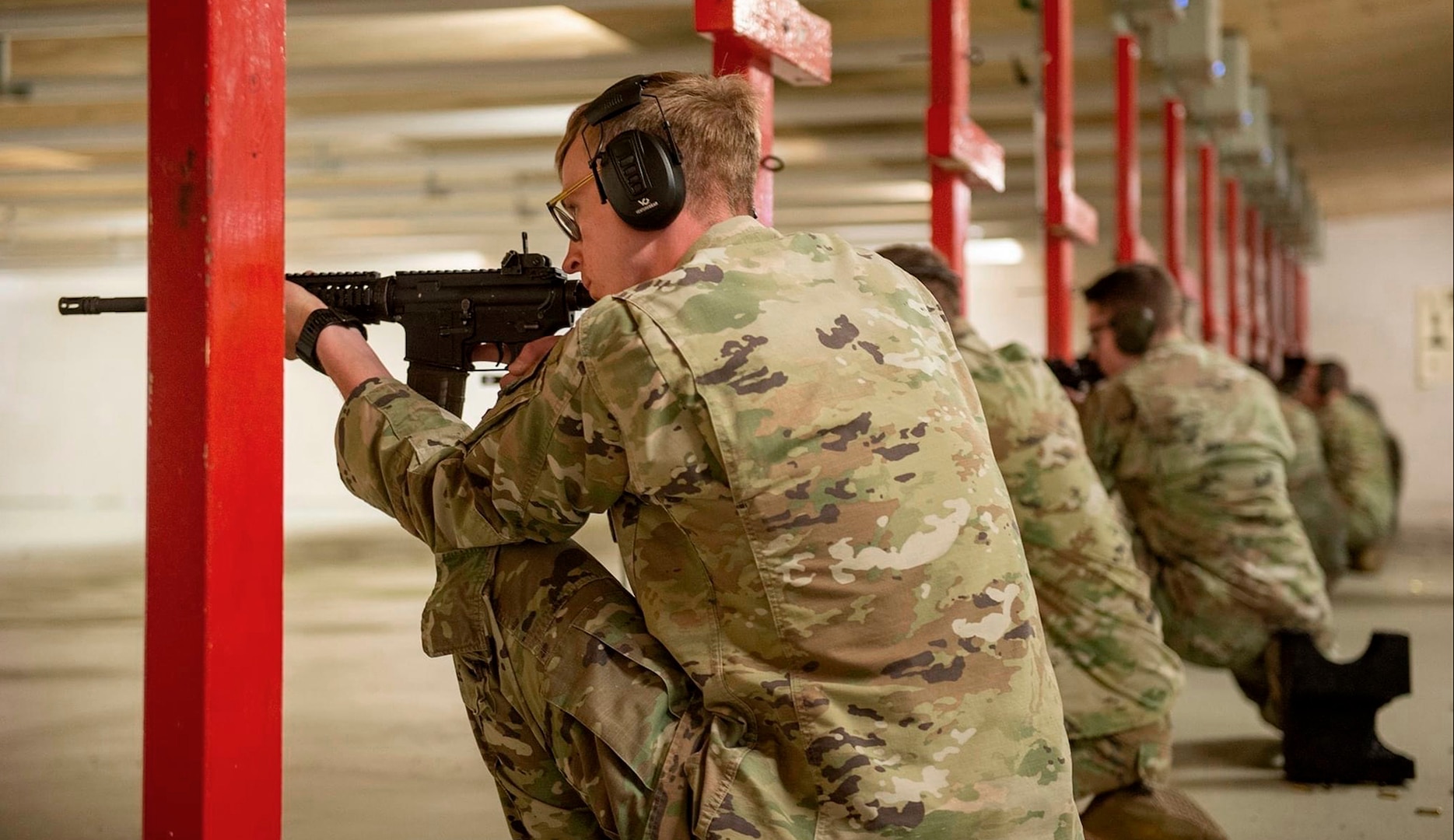 Senior Airman Ryan Hospelhorn fires a M4 carbine at an indoor shooting range. (Contributed photo)