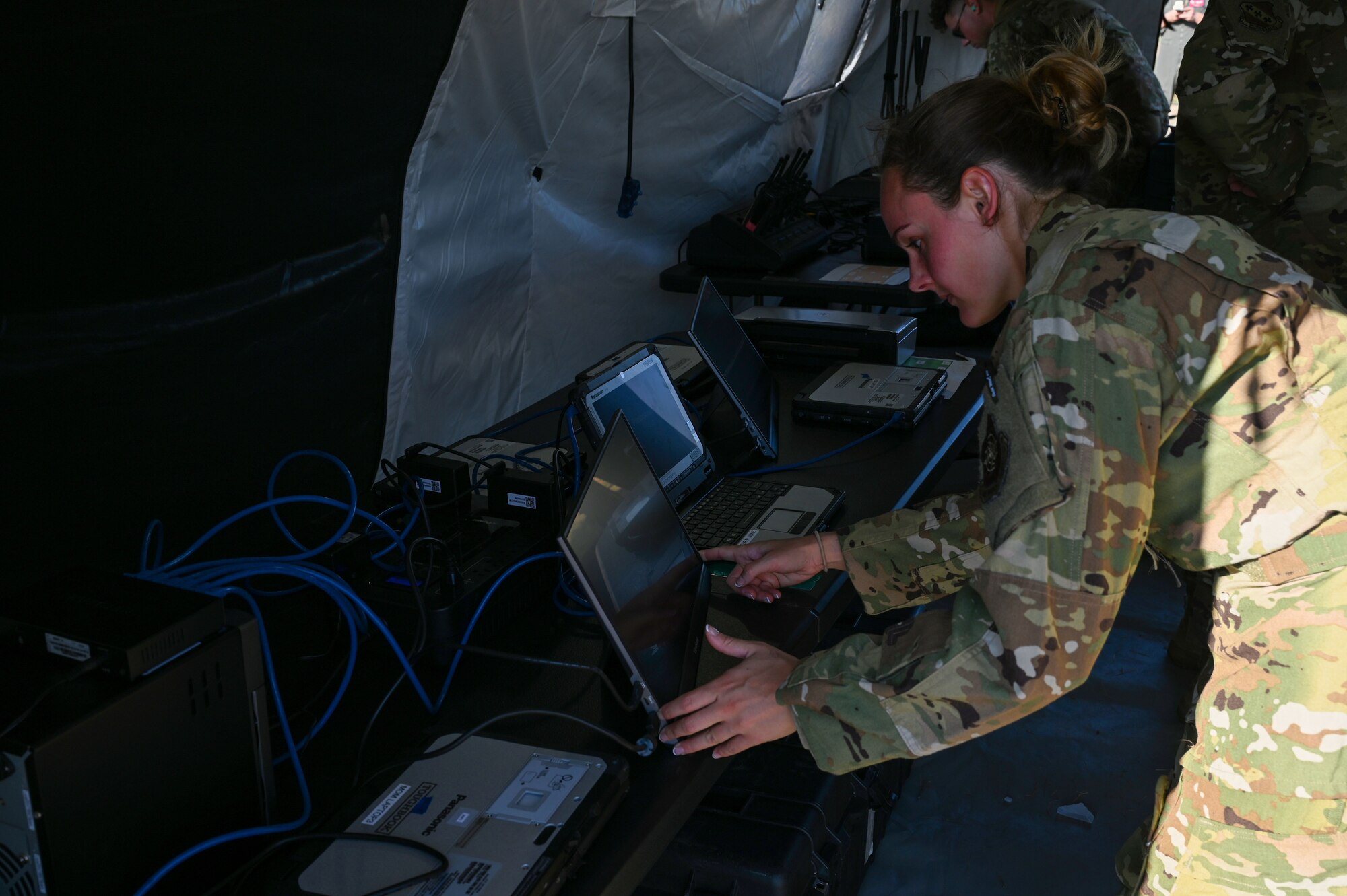 Capt. Anna Santori, 40th Airlift Squadron pilot, assists in setting up communications at Dyess Air Force Base, Texas, Sept. 19, 2023. The Tactical Operating Center demonstration included the set-up of radio communications and secure internet protocol router access. (U.S. Air Force photo by Senior Airman Sophia Robello)