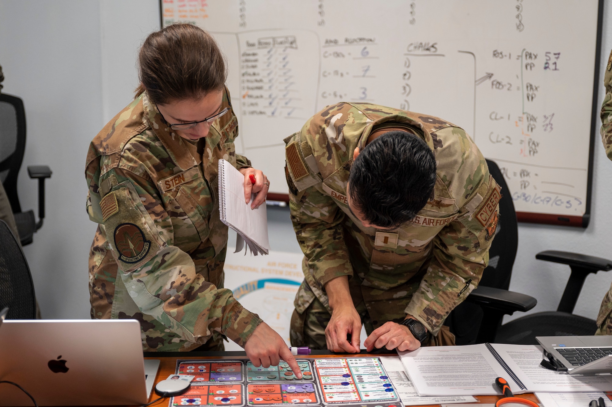 Staff Sgt. Angelica Stein, 7th Operations Support Squadron weather forecaster, and 2nd Lt. Andrew Empeno, 7th Communications Squadron officer in charge of plans and programs, discusses their main operations base’s resources during a table-top exercise.