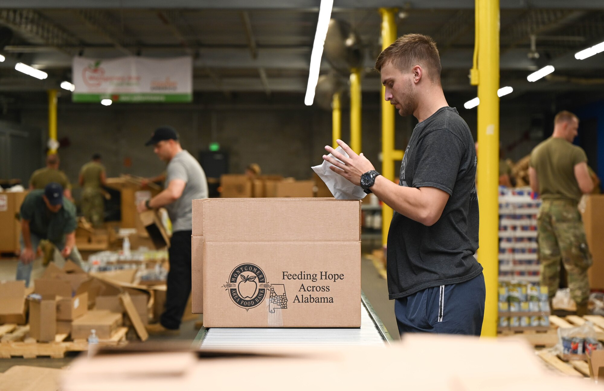 a man packs a box of food