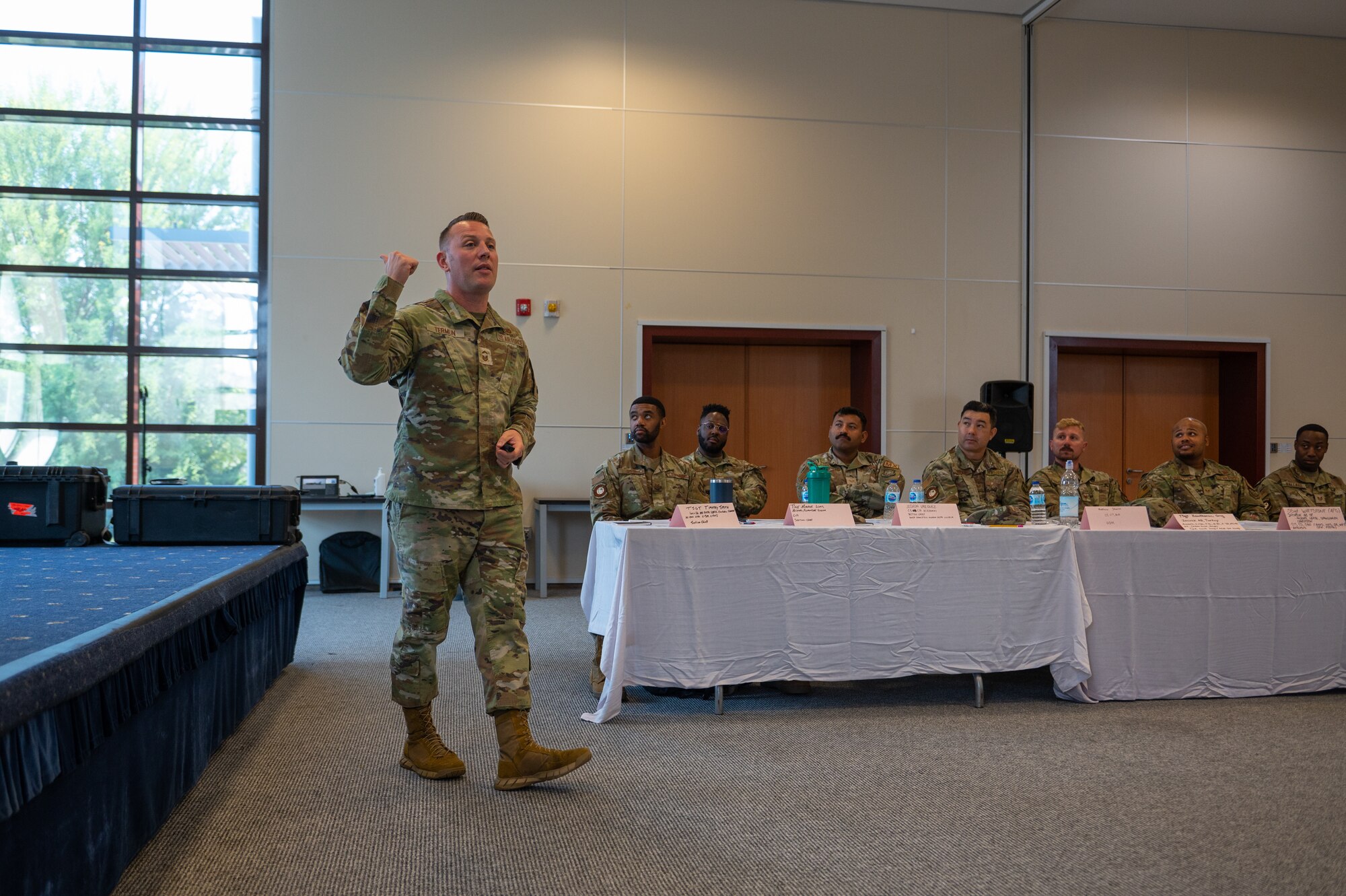An instructor paces the room, illustrating a point