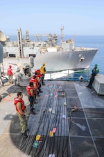 USS Carter Hall (LSD 50) replenishes from USNS Amelia Earhart (T-AKE 6) in the Gulf of Oman.