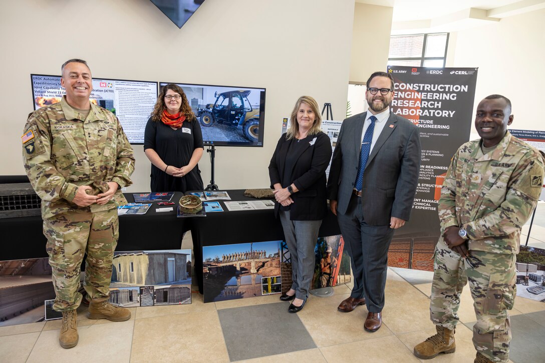 Representatives from the Construction Engineering Research Lab pose with a display of their technology during the ERDC 25th anniversary celebration.