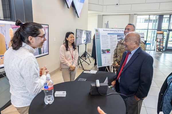 CRREL's Alex Littlefield (left) and Dr. Sora Haley (right) speak with onlookers during the Open House tour.