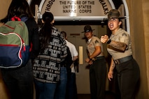U.S. Marine Corps Sgt. Gladys Ruiz, a drill instructor with Receiving Company, Support Battalion, rushes recruits with Lima Company, 3rd Recruit Training Battalion, into the receiving building at Marine Corps Recruit Depot San Diego, Sept. 25, 2023. Receiving is the first event during recruit training where recruits are checked for contraband, given a haircut, issued gear and make a phone call home. (U.S. Marine Corps photo by Sgt. Yvonna Guyette)