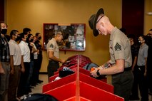 U.S. Marine Corps Sgt. Christophe Blossom, a drill instructor with Receiving Company, Support Battalion, looks through recruits' belongings with Lima Company, 3rd Recruit Training Battalion during receiving at Marine Corps Recruit Depot San Diego, Sept. 25, 2023. Receiving is the first event during recruit training where recruits are checked for contraband, given a haircut, issued gear and make a phone call home. (U.S. Marine Corps photo by Sgt. Yvonna Guyette)