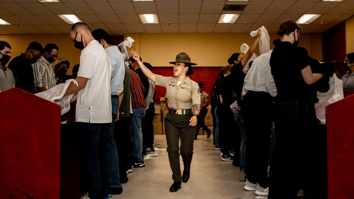 U.S. Marine Corps Sgt. Gladys Ruiz, a drill instructor with Receiving Company, Support Battalion, instructs recruits with Lima Company, 3rd Recruit Training Battalion, during receiving at Marine Corps Recruit Depot San Diego, Sept. 25, 2023. Receiving is the first event during recruit training where recruits are checked for contraband, given a haircut, issued gear and make a phone call 
home. (U.S. Marine Corps photo by Sgt. Yvonna Guyette)