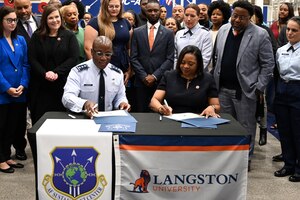 U.S. Air Force Lt. Gen. Stacey T. Hawkins, Air Force Sustainment Center commander, speaks with guests after a ground-breaking agreement was brokered on Sept. 25 when he and Dr. Ruth Ray Jackson, Langston University interim president, signed official documents establishing an educational partnership agreement between the two entities.