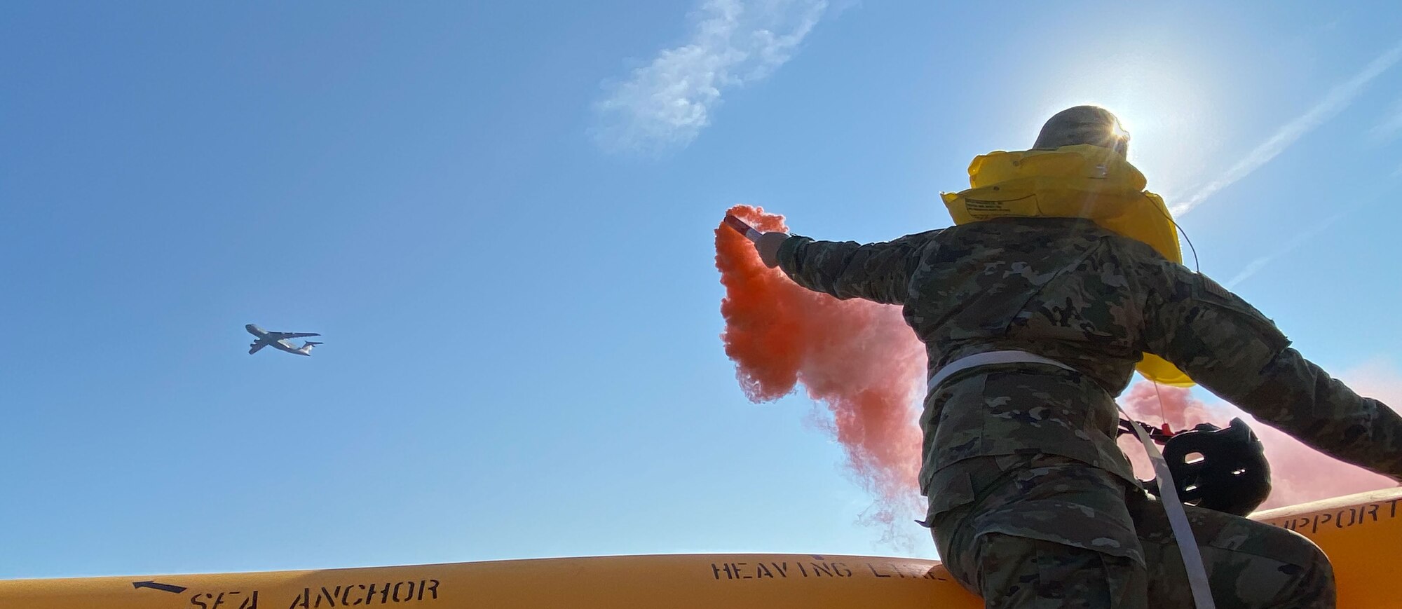 U.S. Air Force Senior Master Sgt. Abigail Diaz, 436th Operations Support Squadron Air Traffic Control training superintendent, uses a flare to signal a U.S. Air Force C-5M Super Galaxy during Exercise Castaway 23-3 near Indian River Inlet, Delaware, Sept. 6, 2023. Castaway 23-3 was a Total Force, Interagency training exercise designed to train and update local search and rescue procedures. (U.S. Air Force photo by Airman 1st Class Dieondiere Jefferies)