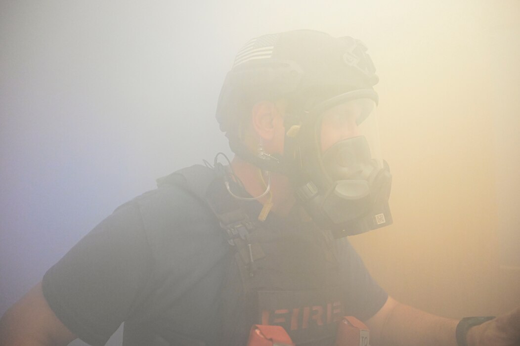 Alan Hebert, 17th Civil Engineer Squadron firefighter, navigates around a smoky environment during the Rescue Task Force course of the Threat Suppression Inc. exercise, Goodfellow Air Force Base, Texas, Sep. 21, 2023. Participants in this practical exercise entered a building with various lighting conditions as well as fog to perform a search and rescue. Members of the 17th Security Forces Squadron, the 17th CES fire department, and local Tom Green County Sheriff's Office officers participated in a week of classroom and practical exercises to prepare them for real world scenarios. (U.S. Air Force photo by Airman 1st Class Madison Collier)