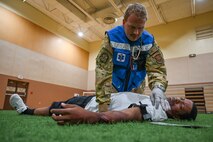 An Airman from the 341st Medical Group treats a simulated casualty during Ready EAGLE II, a training exercise held biennially at Malmstrom Air Force Base, Mont., Sept. 21, 2023. Prior to the exercise, the Ready EAGLE II contractor provided hands-on training and tabletop exercise for 341 MDG’s command, field response and decontamination teams. (U.S. Air Force photo by Senior Airman Breanna Christopher Volkmar)