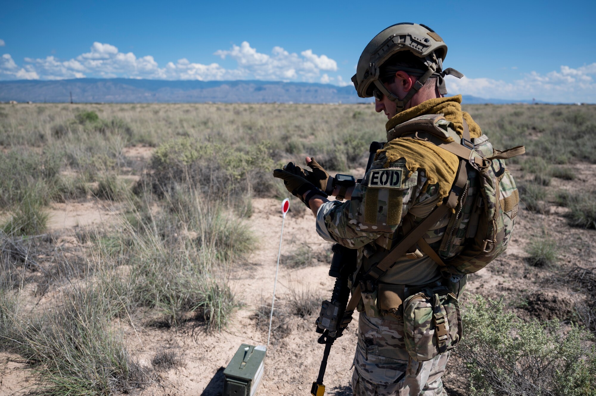 U.S. Air Force Senior Airman Patrick Conte,  49th Civil Engineer explosive ordnance disposal training manager, finds a land navigation marker during an exercise at Holloman Air Force Base, New Mexico, Sep. 20, 2023. The EOD flight applies special techniques and procedures to lessen or remove the hazards created by the presence of unexploded ordnance. (U.S. Air Force photo by Airman 1st Class Michelle Ferrari)