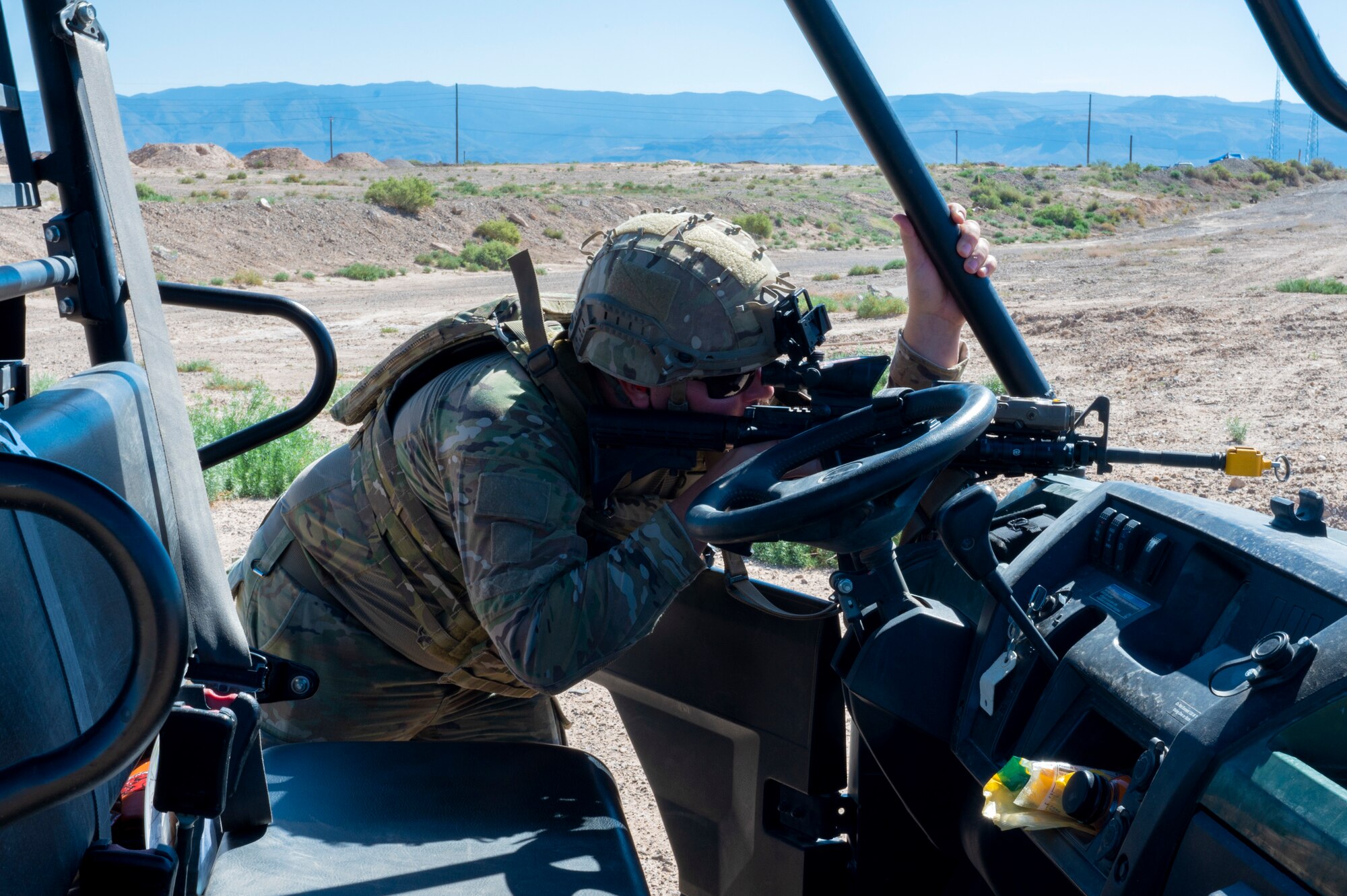 U.S. Air Force Staff Sgt. Kelsey Smith, 49th Civil Engineer explosive ordnance disposal NCO of equipment, scouts for enemies during an exercise  at Holloman Air Force Base, New Mexico, Sep. 20, 2023. The EOD flight performs special tasks such as recovering the body of an enemy killed in action during a site exploitation training exercise. (U.S. Air Force photo by Airman 1st Class Michelle Ferrari)