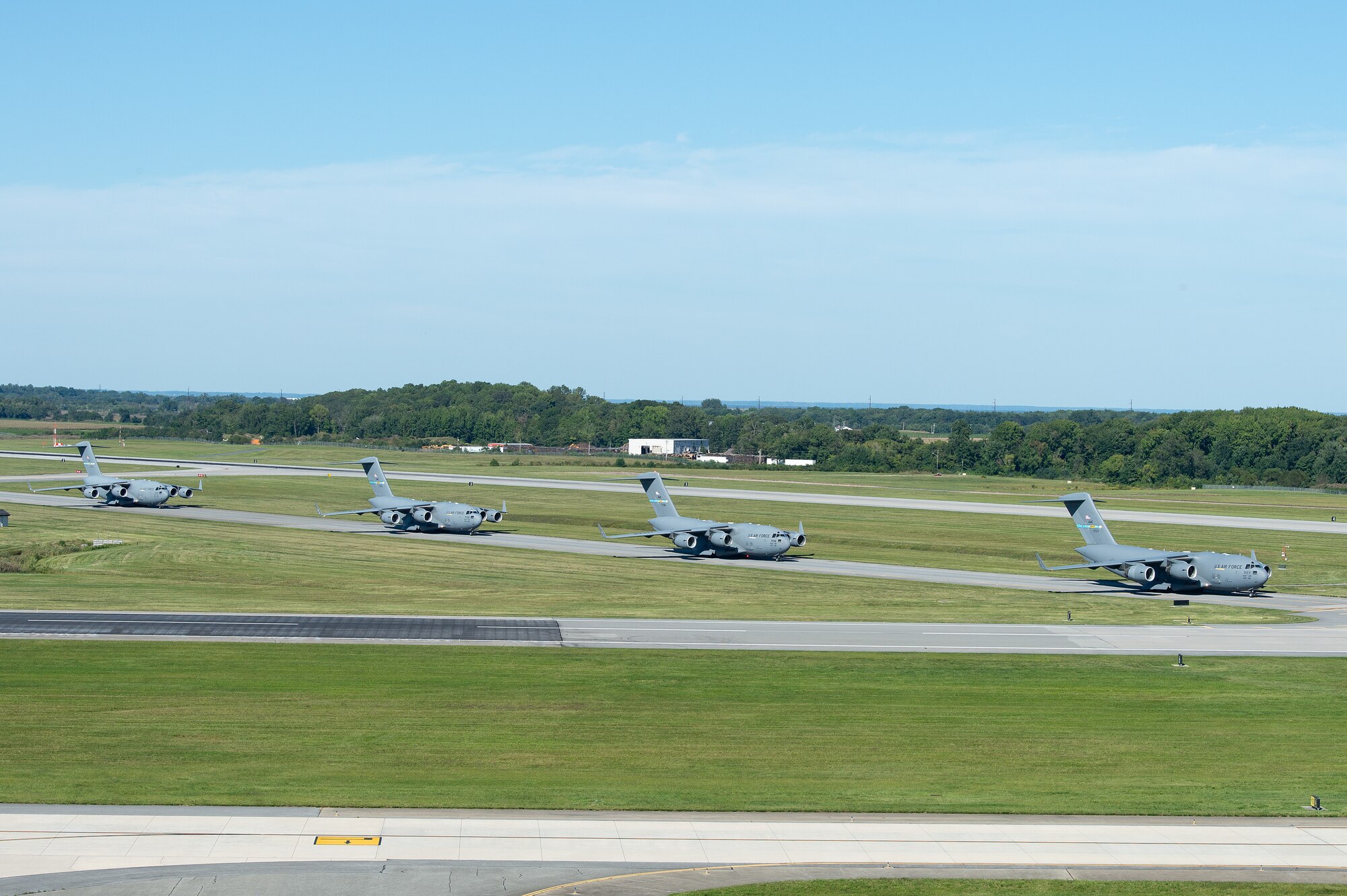 Four C-17 Globemaster IIIs assigned to Dover Air Force Base, Delaware, taxi to their parking spot after returning to home station from Agile Royal on Sept. 15, 2023. The 3rd AS evaluated their ability to successfully execute Air Mobility Command capabilities and conduct operations in a high threat environment during the Agile Royal C-17 Air Force Force Generation certification event. (U.S. Air Force photo by Roland Balik)