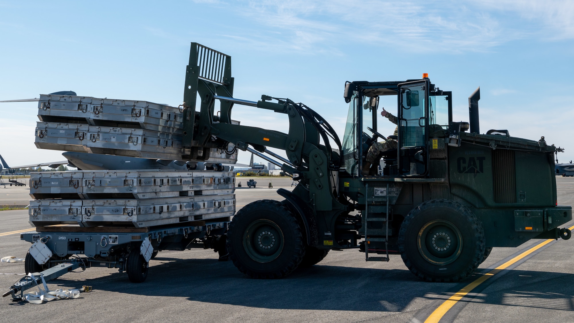 U.S. Air Force Tech. Sgt. Richard Langston, assigned to 3rd Munitions Squadron, operates machinery while loading cargo onto a C-17 Globemaster III during the second annual Nimble Flurry exercise on Joint Base Elmendorf-Richardson, Alaska, Sept 19, 2023.