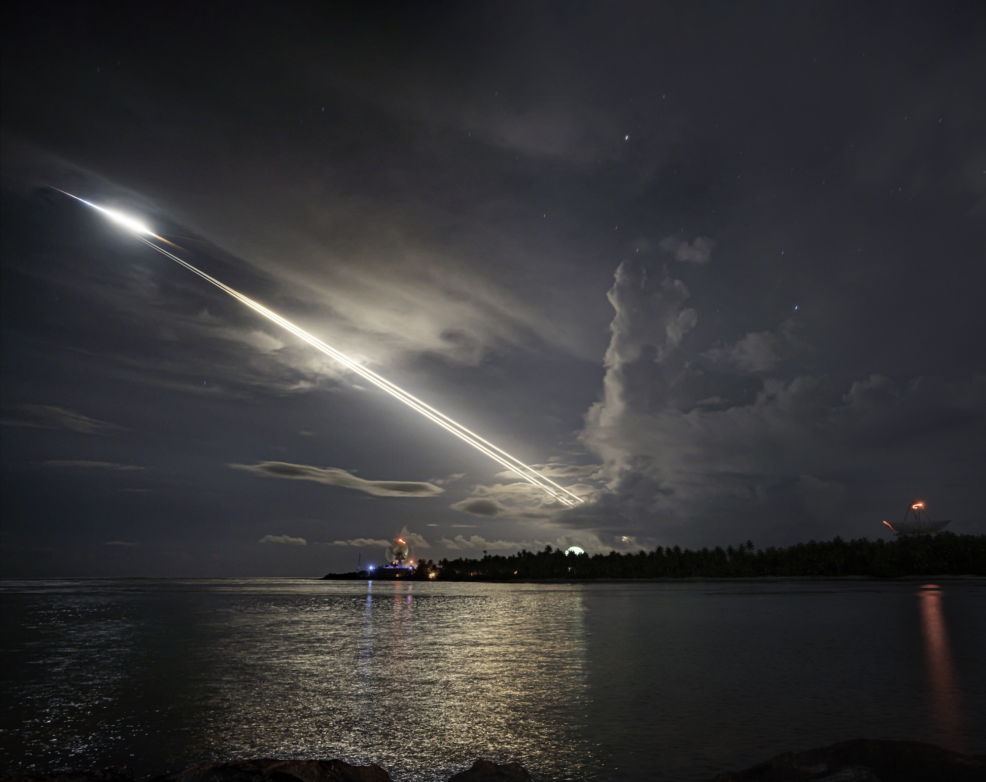 Lines of light streak across the night sky from unarmed ICBMs