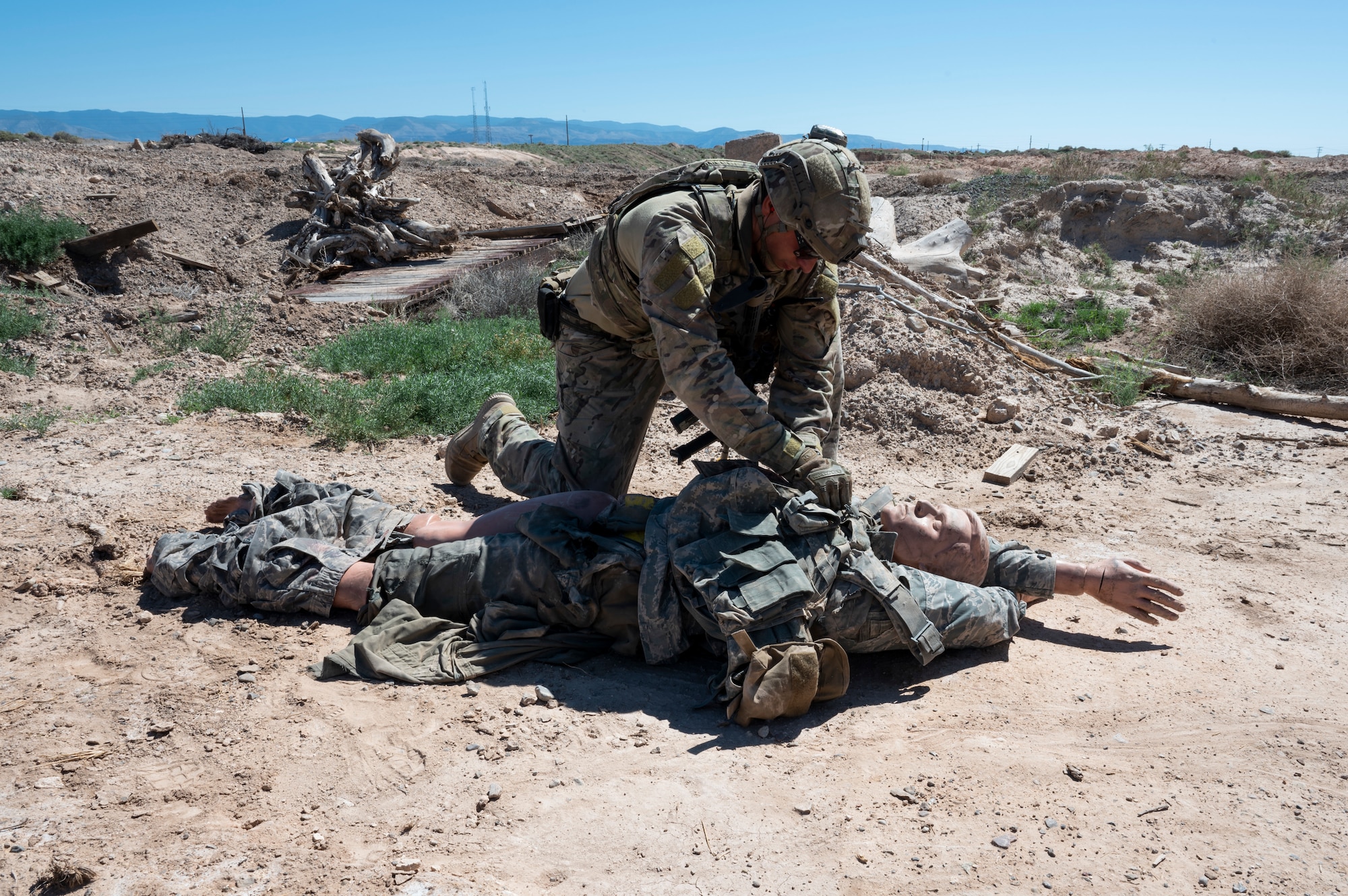 U.S. Air Force Senior Airman Tyler Copley, 49th Civil Engineer Squadron explosive ordnance disposal operations manager, clears a dummies body for explosives during an exercise  at Holloman Air Force Base, New Mexico, Sep. 20, 2023. The EOD flight performs special tasks such as recovering the body of an enemy killed in action during a site exploitation training exercise. (U.S. Air Force photo by Airman 1st Class Michelle Ferrari)