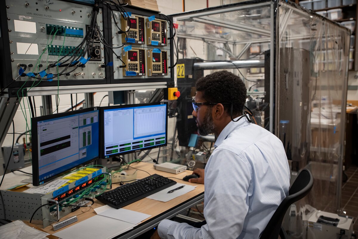 A man sits at a computer terminal.