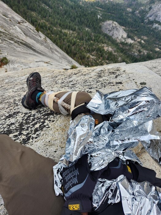 a photo of a climber with a broken leg and a blanket