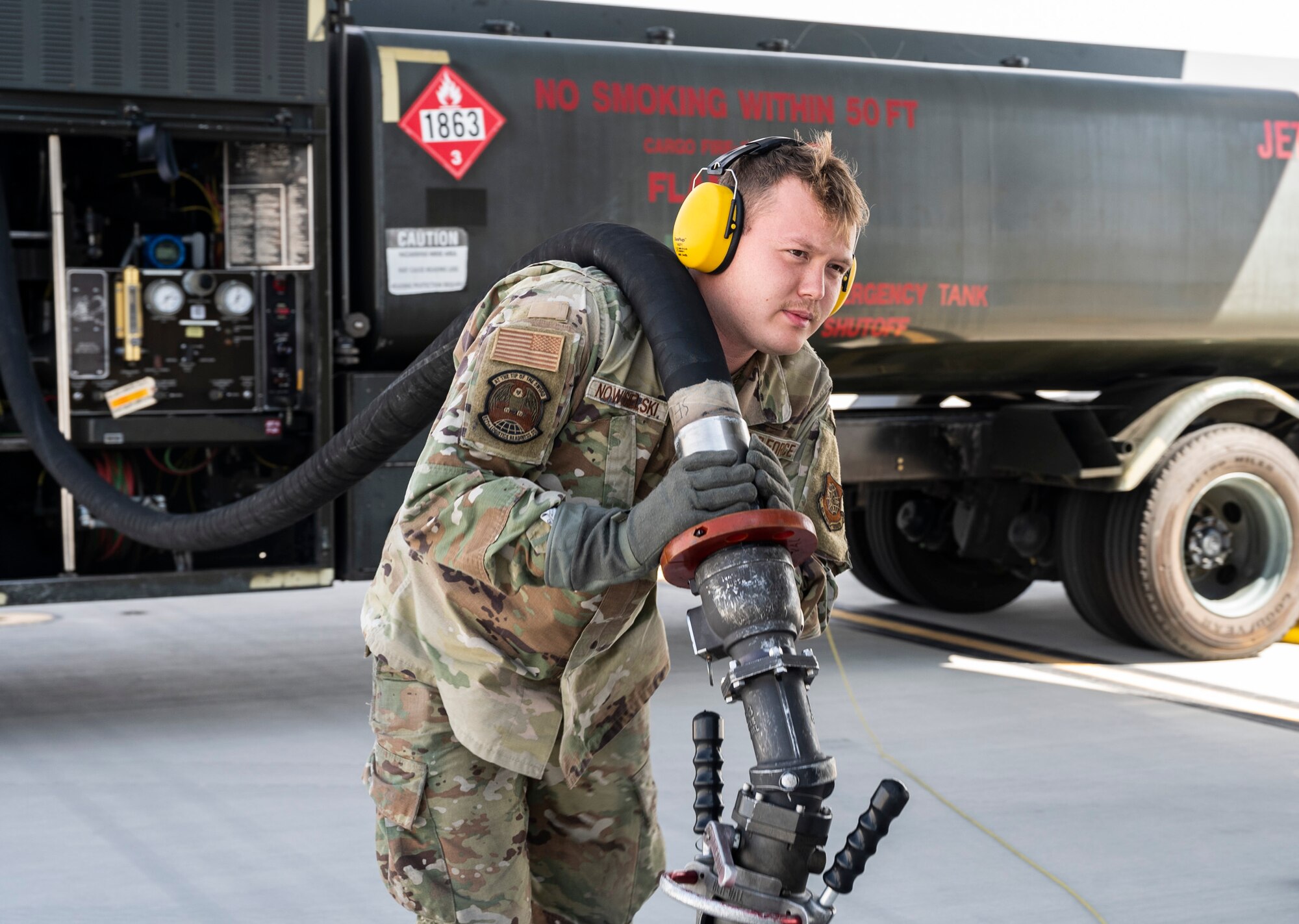 U.S. Air Force Senior Airman Joseph Nowosielski, a fuels apprentice with the 627th Logistics Readiness Squadron, drags a fuel hose to a C-17 Globemaster III during Exercise Rainier War 23A at Mountain Home Air Force Base, Idaho, Sept. 25, 2023. Rainier War is an annual exercise led by the 62d Airlift Wing designed to evaluate the ability to generate, employ and sustain in-garrison and forward deployed forces. These exercises are necessary in assessing and maintaining wartime operational tempos, ensuring command and control across multiple locations. During the exercise, Airmen will respond to scenarios that replicate today’s contingency operations and will address full-spectrum readiness against modern threats brought on by peer adversaries. (U.S. Air Force photo by Staff Sgt. Rachel Williams)