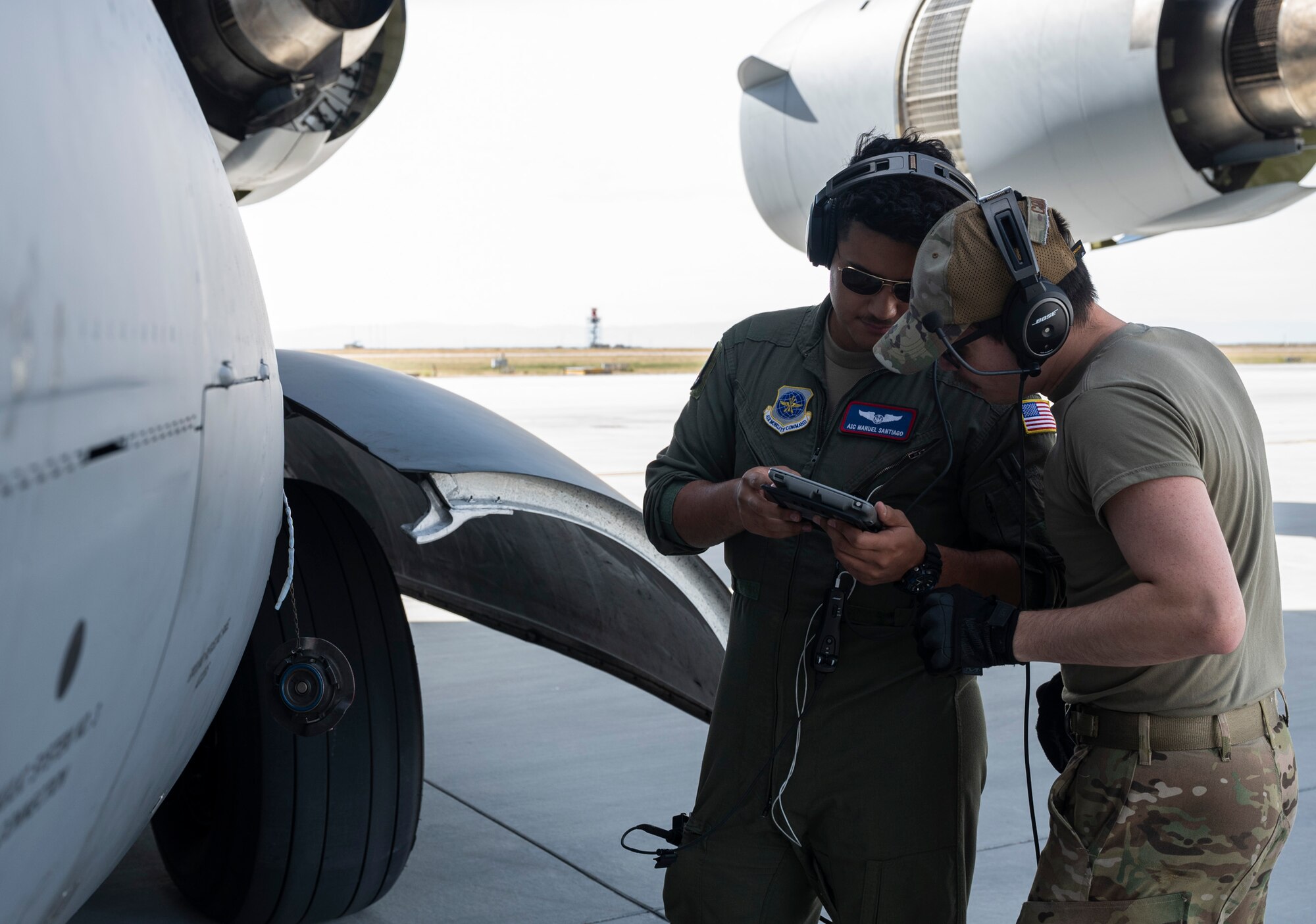 U.S. Air Force Airman 1st Class Manuel Santiago, left, and Senior Airman Kainoa Cook, both loadmasters with the 4th Airlift Squadron, review a checklist while performing specialized fueling operations during Exercise Rainier War 23A at Mountain Home Air Force Base, Idaho, Sept. 25, 2023. Rainier War is an annual exercise led by the 62d Airlift Wing designed to evaluate the ability to generate, employ and sustain in-garrison and forward deployed forces. These exercises are necessary in assessing and maintaining wartime operational tempos, ensuring command and control across multiple locations. During the exercise, Airmen will respond to scenarios that replicate today’s contingency operations and will address full-spectrum readiness against modern threats brought on by peer adversaries. (U.S. Air Force photo by Staff Sgt. Rachel Williams)