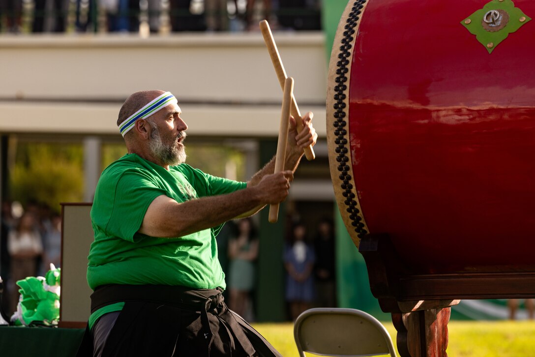 David Wray, a physical education and health teacher at Kubasaki high School plays a Taiko Drum during a Ringing of the Bell ceremony at Kubasaki High School on Camp Foster, Okinawa, Japan, Aug. 21, 2023. To welcome back students on the first day of school, Kubasaki High School held a ceremony that featured Taiko drums that were donated by Yoshinori Arakaki. 

“I donated these drums as a gift because I heard that Kubasaki High School has a drum class, and I wanted them to learn more about Japanese culture,” said Arakaki. “I was so thrilled to see so many students appreciate the Taiko drums and welcome me to their school on such a large scale.”  

Arakaki was born in Yomitan Village, Okinawa in 1941. From 1962 to 1972 he worked at White Beach for ten years as a bartender. Since 1978, he has run a Sanshin shop and owns a factory in Vietnam where he stores Taiko drums.
