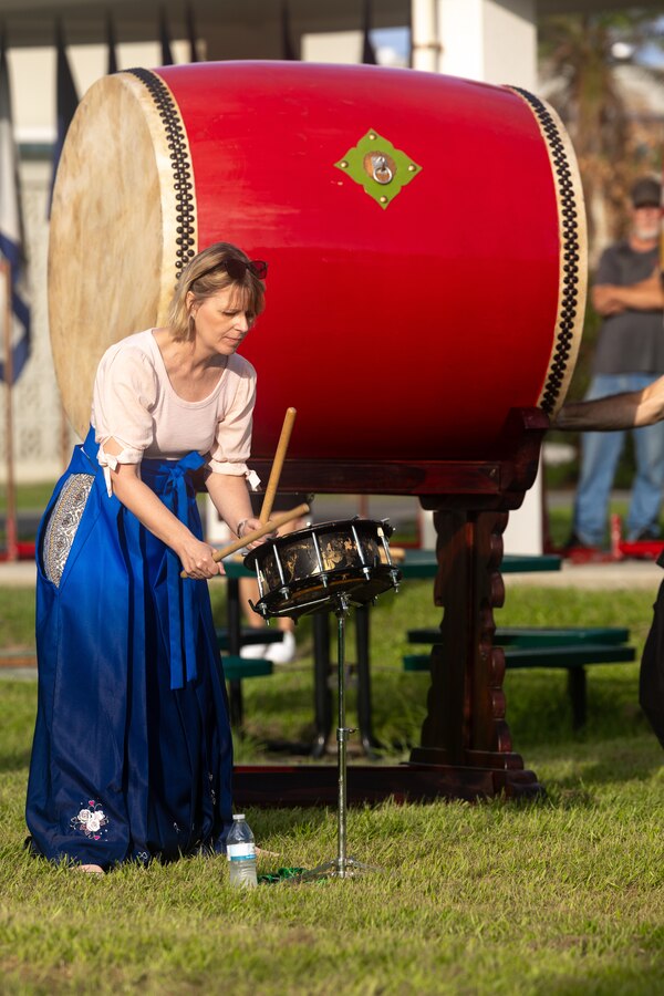 Susanne Wall, a music teacher at Kubasaki High School, plays the drums during a Ringing of the Bell ceremony at Kubasaki High School on Camp Foster, Okinawa, Japan, Aug. 21, 2023. To welcome back students on the first day of school, Kubasaki High School held a ceremony that featured Taiko drums that were donated by Yoshinori Arakaki. 

“I donated these drums as a gift because I heard that Kubasaki High School has a drum class, and I wanted them to learn more about Japanese culture,” said Arakaki. “I was so thrilled to see so many students appreciate the Taiko drums and welcome me to their school on such a large scale.”  

Arakaki was born in Yomitan Village, Okinawa in 1941. From 1962 to 1972 he worked at White Beach for ten years as a bartender. Since 1978, he has run a Sanshin shop and owns a factory in Vietnam where he stores Taiko drums.