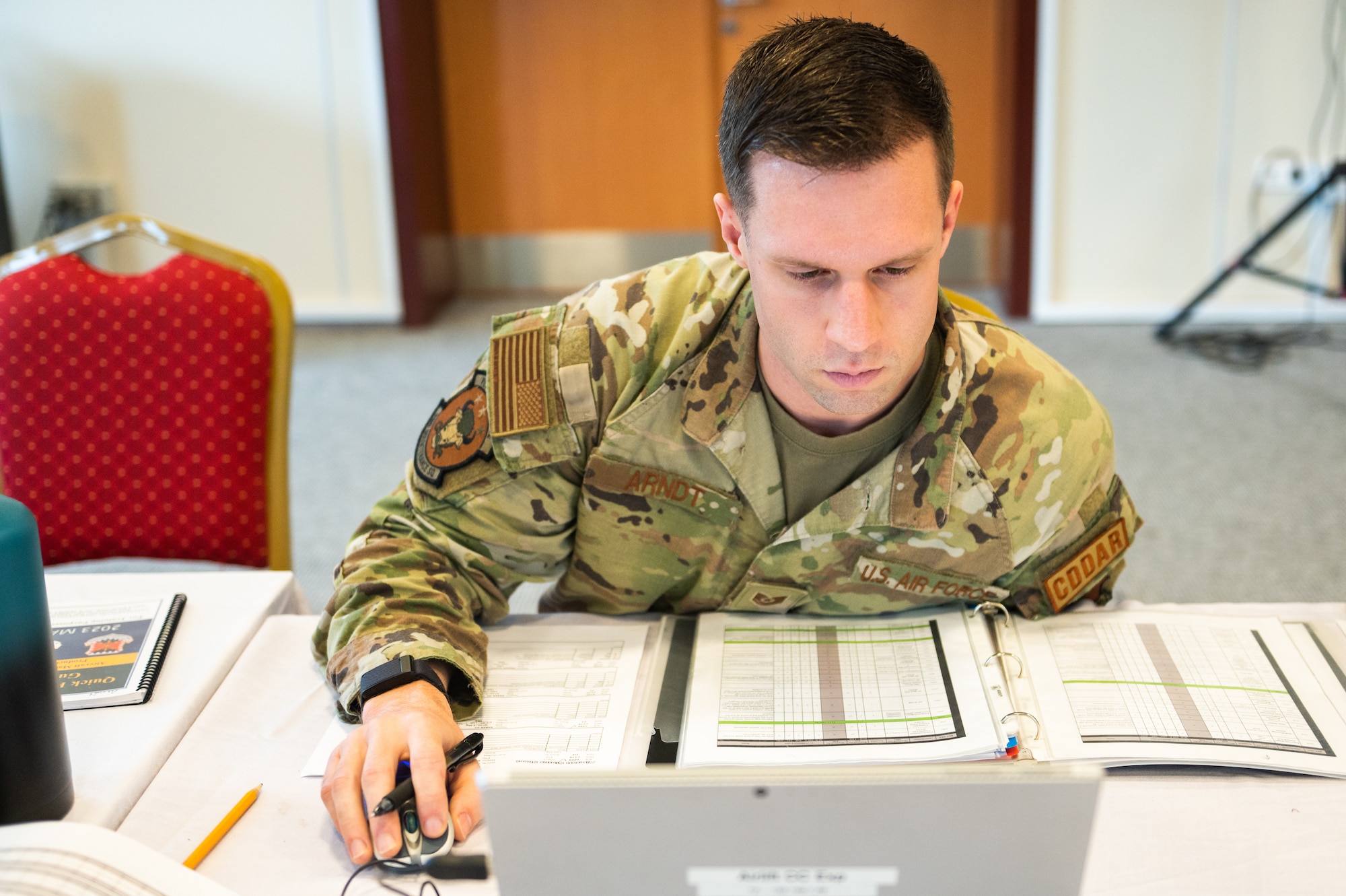 Airman stares intensely at his computer screen