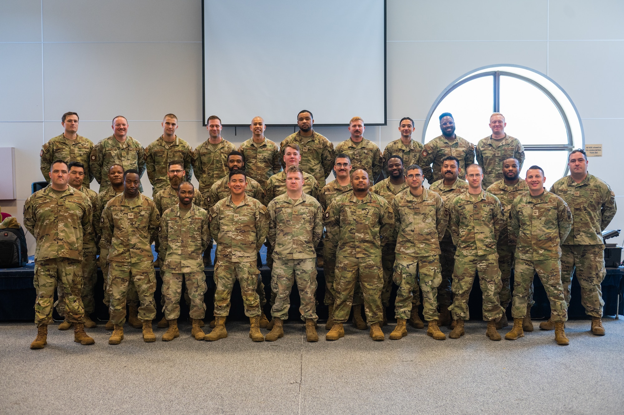 Course graduates stand in formation at parade rest