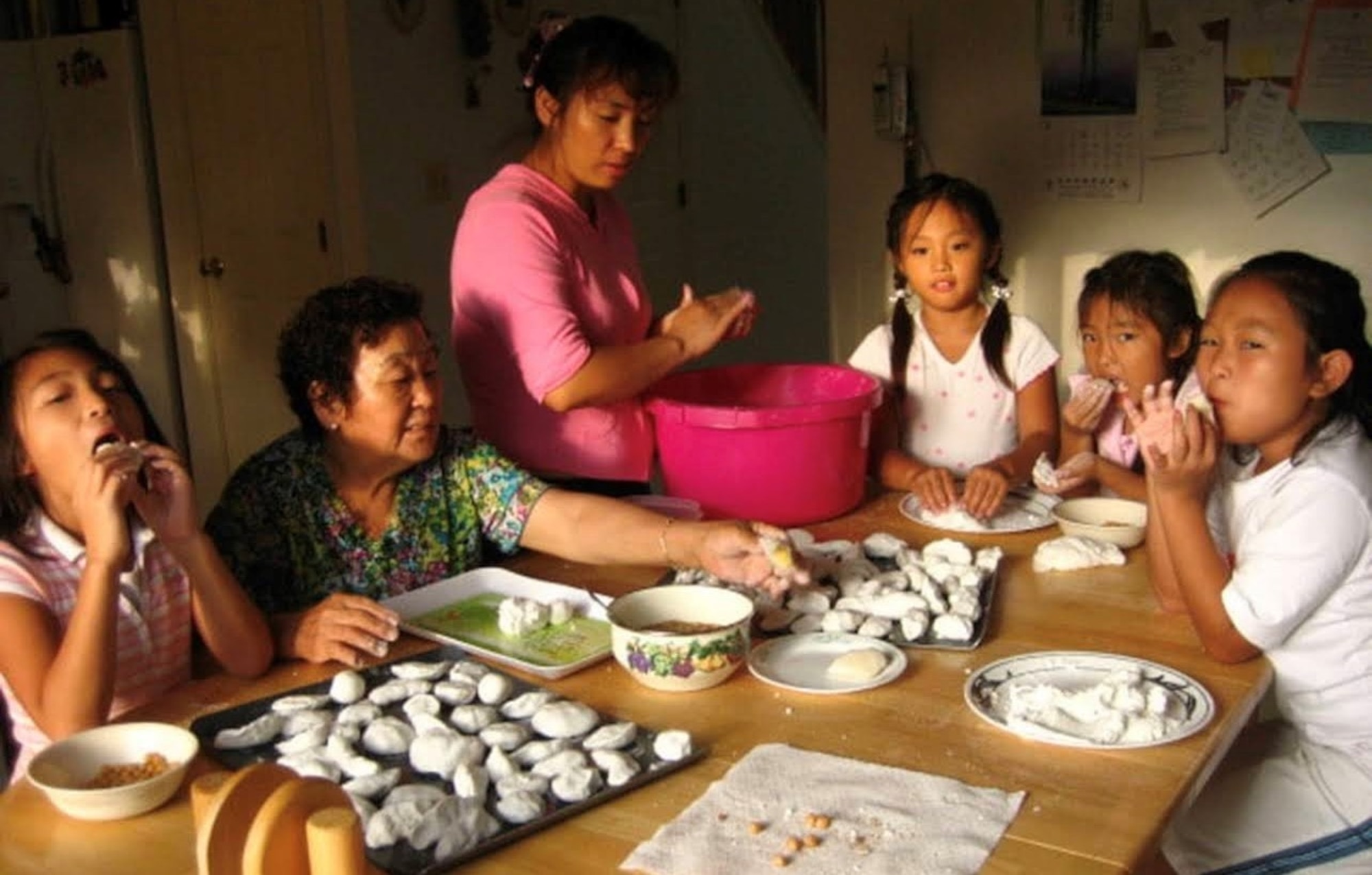 Airman 1st Class Hyeon Jung, 8th Communications Squadron cybersecurity technician, makes rice cakes with her family during Chuseok.