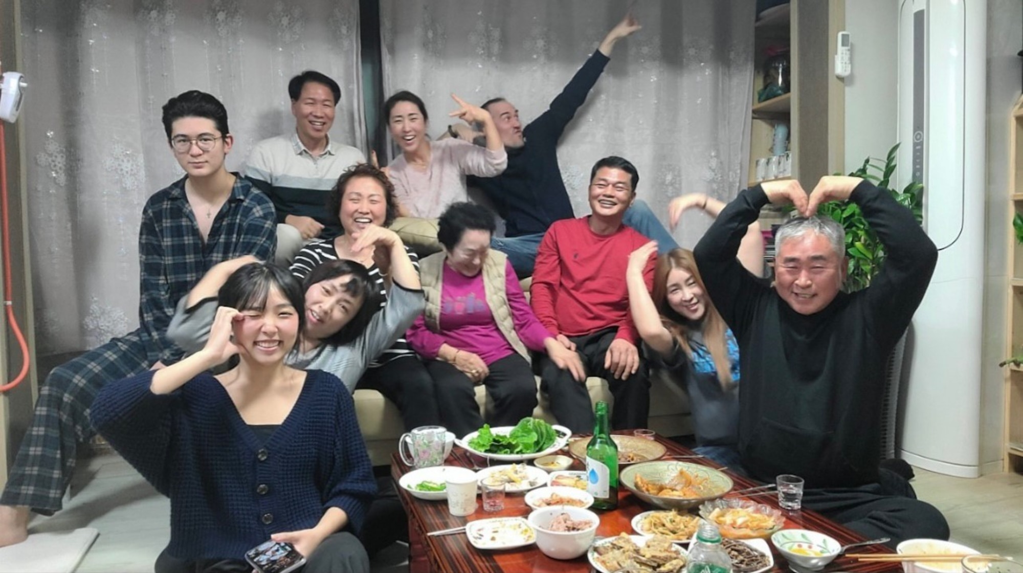 Airman 1st Class Hyeon Jung, bottom left, 8th Communications Squadron cybersecurity technician, gathers with family for a photo during Chuseok.