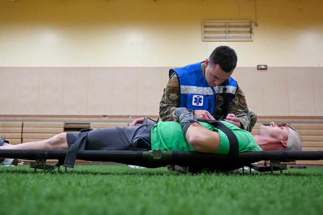 Staff Sgt. Eric Hoff, 341st Medical Group noncommissioned officer in charge of the base operational medical cell, prepares to transport a simulated casualty to triage during Ready EAGLE II, a training exercise held biennially at Malmstrom Air Force Base, Mont., Sept. 21, 2023. The exercise included a response to a chemical, biological, radiological and nuclear disaster allowing the medics to train their triage, decontamination, treatment and patient tracking skills for roughly 60 volunteer actors. (U.S. Air Force photo by Senior Airman Breanna Christopher Volkmar)