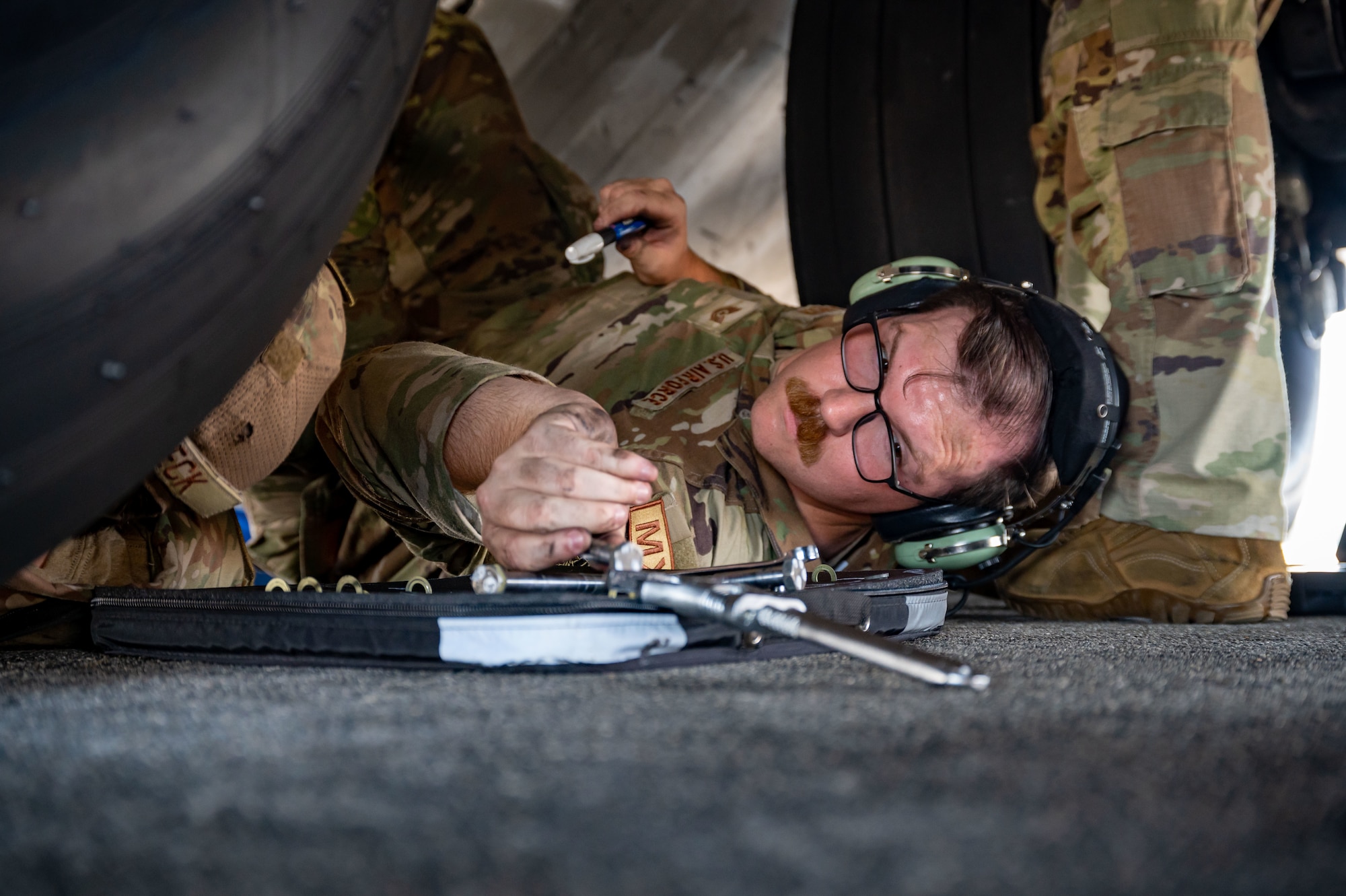 U.S. Air Force Tech. Sgt. Robert Johnson, 736th Aircraft Maintenance Squadron home station check dock chief, reaches for tools while removing the inboard landing door on a U.S. Air Force C-17 Globemaster III at Hunter Army Airfield, Georgia, during the Agile Royal C-17 Air Force Force Generation certification event, Sept. 13, 2023. The 436th, 736th and 712th AMXS evaluated their ability to transition from peacetime readiness to contingency operations during Agile Royal. (U.S. Air Force photo by Airman 1st Class Amanda Jett)