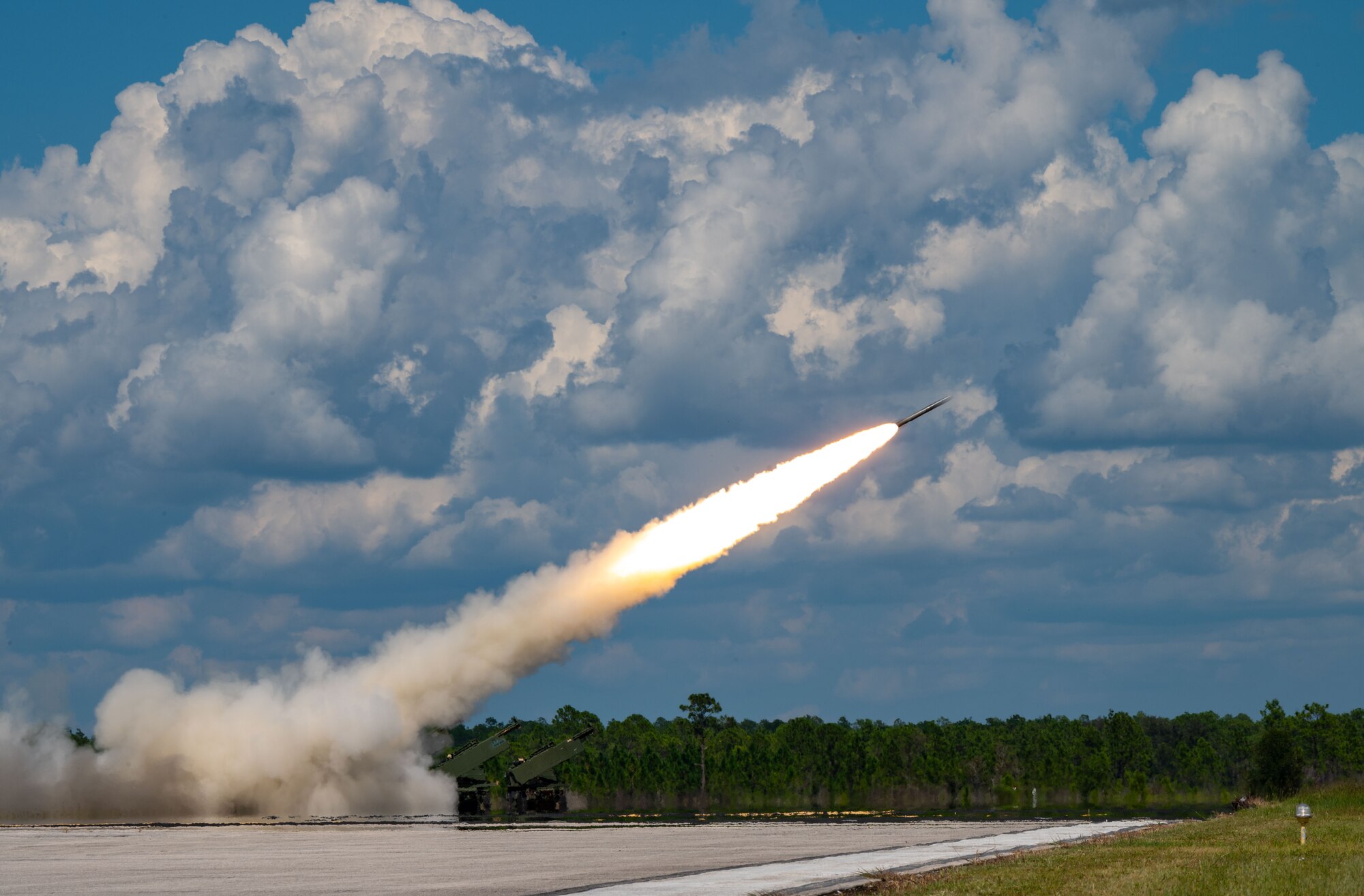 A M142 High Mobility Artillery Rocket System fires rockets during the Agile Royal C-17 Air Force Force Generation certification event at Avon Park Air Force Range, Florida, Sept. 14, 2023. The 3rd Airlift Squadron evaluated their ability to successfully execute Air Mobility Command capabilities, enhance joint interoperability with other U.S. military branches and conduct operations in a high threat environment during Agile Royal. (U.S. Air Force photo by Airman 1st Class Amanda Jett)