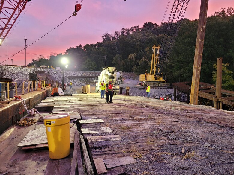 C.J. Mahan work crews position concrete delivery trucks onto a barge Sept. 20, 2023, on the upstream side of Chickamauga Dam that placed 148 cubic yards of tremie concrete into a tremie pipe and shaft on the bottom of the Tennessee River for the first of 14 shafts for the upstream approach wall piers. The U.S. Army Corps of Engineers Nashville District Upstream Approach Wall construction is an integral part of the Chickamauga Lock Replacement Project in Chattanooga, Tennessee. (USACE Photo by Matthew Curvin)