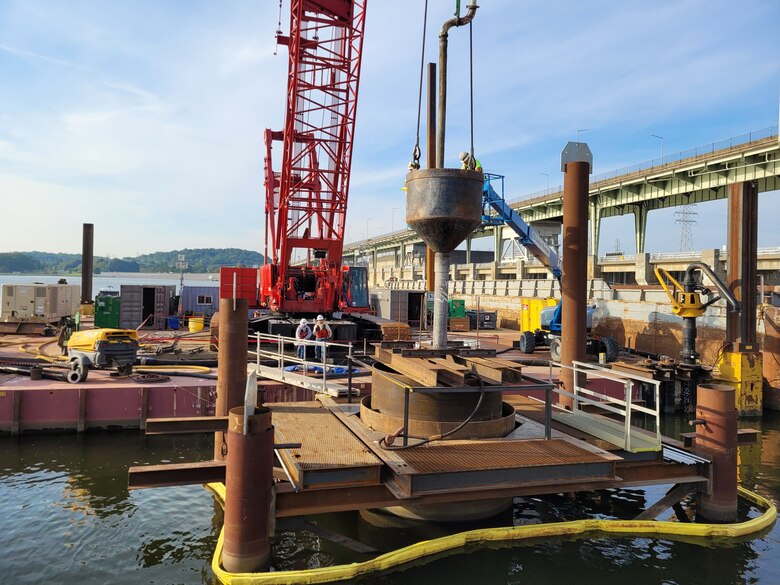 C.J. Mahan work crews prepare to place 148 cubic yards of tremie concrete Sept. 20, 2023, from a pump truck into a tremie pipe for placement into the shaft on the bottom of the Tennessee River for the first of 14 shafts for the upstream approach wall piers. The U.S. Army Corps of Engineers Nashville District Upstream Approach Wall construction is an integral part of the Chickamauga Lock Replacement Project in Chattanooga, Tennessee. (USACE Photo by Matthew Curvin)