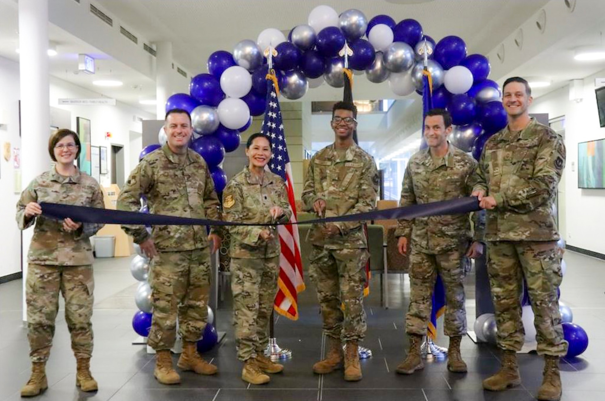 52nd Fighter Wing leadership and members from the 52nd Medical Group cut ribbon during the MHS Genesis ribbon cutting ceremony.