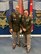 Two men U.S. Army uniforms pose for a photo.