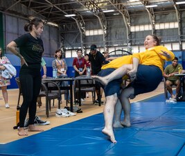Angela "Unstoppable" Lee watches Sailors and Marines from USS Pearl Harbor (LSD 52) practice takedowns during a port stop for Pacific Partnership 2023.