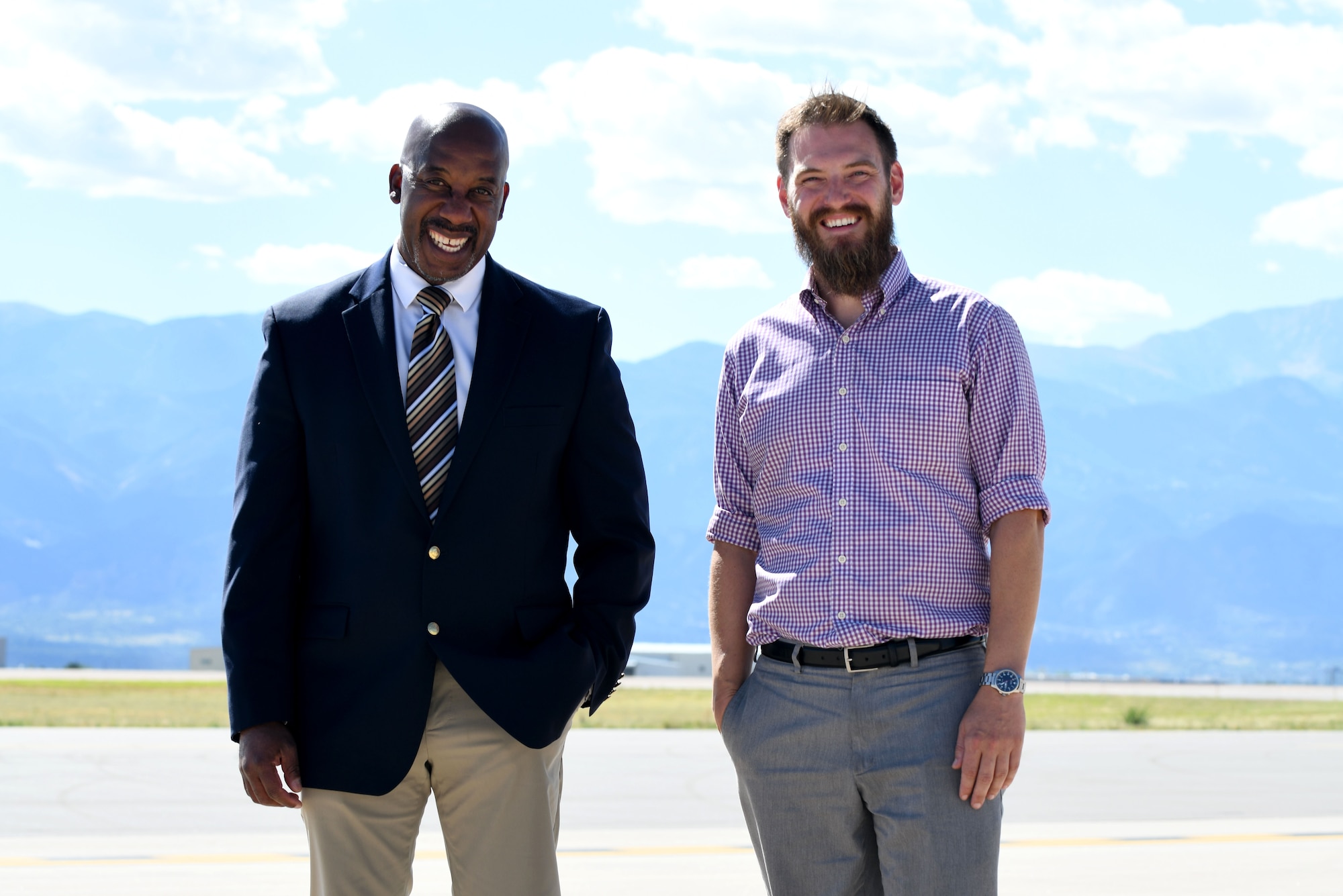 Two gentlemen stand on the Peterson ramp smiling