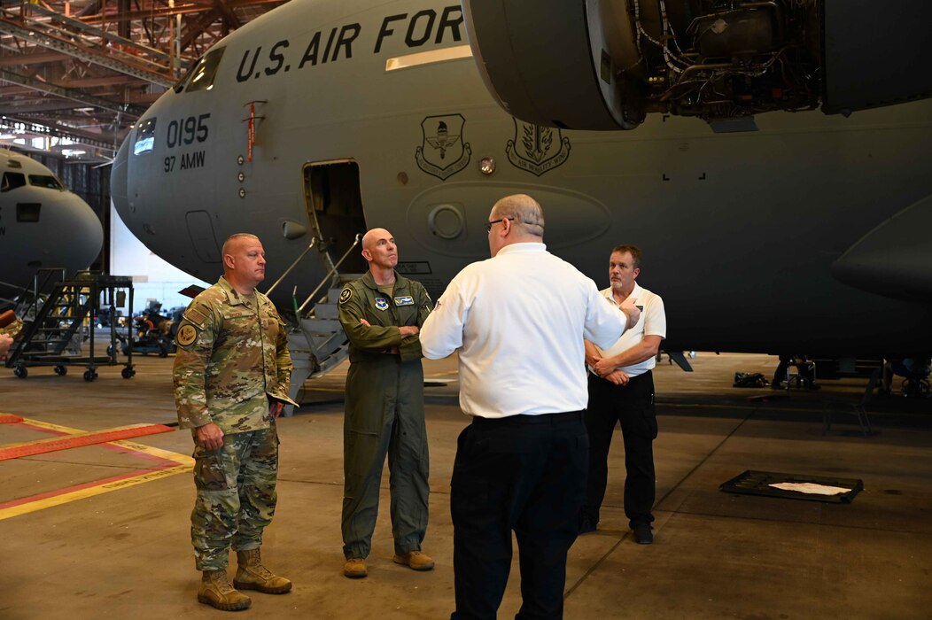 Jeff Gobeille, 97th Maintenance Squadron superintendent, gives Maj. Gen. Clark Quinn, 19th Air Force commander and Chief Master Sgt. Justin Apticar, 19th Air Force command chief, a tour of Hangar 285 at Altus Air Force Base, Oklahoma, Sept. 20, 2023. The 97th Maintenance Squadron provides on and off-equipment aircraft and component maintenance to ensure safe, reliable aircraft for the Air Force’s mobility aircrew formal training mission. (U.S. Air Force photo by Kari Degraffenreed)