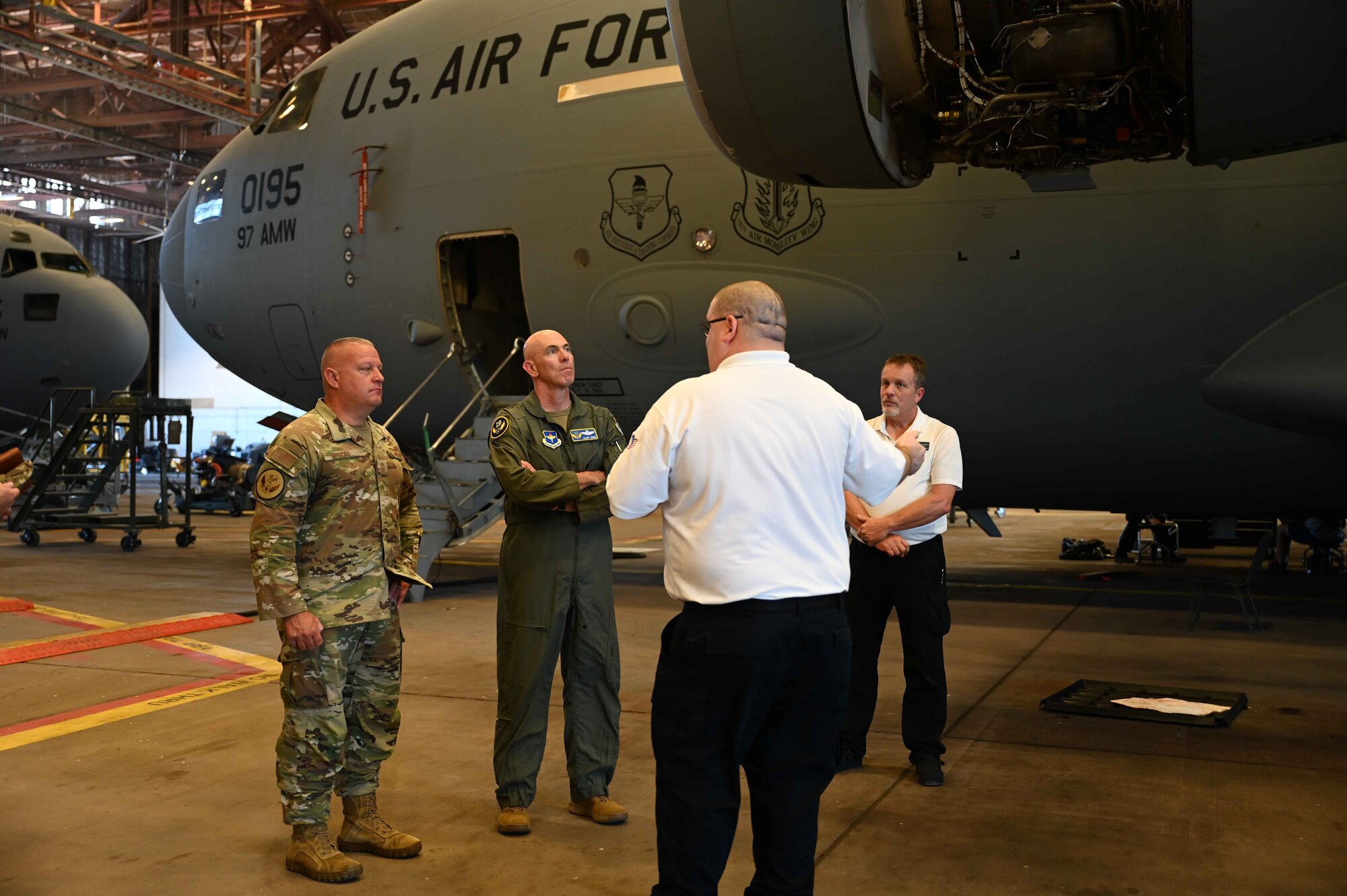Jeff Gobeille, 97th Maintenance Squadron superintendent, gives Maj. Gen. Clark Quinn, 19th Air Force commander and Chief Master Sgt. Justin Apticar, 19th Air Force command chief, a tour of Hangar 285 at Altus Air Force Base, Oklahoma, Sept. 20, 2023. The 97th Maintenance Squadron provides on and off-equipment aircraft and component maintenance to ensure safe, reliable aircraft for the Air Force’s mobility aircrew formal training mission. (U.S. Air Force photo by Kari Degraffenreed)
