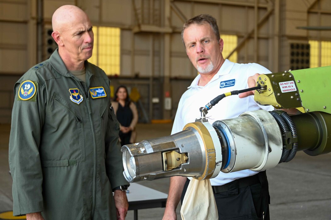 Donnie Obreiter, 97th Maintenance Squadron director, shows Maj. Gen. Clark Quinn, 19th Air Force commander, the boom pod of a KC-46 Pegasus at Altus Air Force Base, Oklahoma, Sept. 20, 2023. The KC-46 is equipped with a refueling boom driven by a fly-by-wire control system and is capable of fuel offload rates required for large aircraft. (U.S. Air Force photo by Airman 1st Class Kari Degraffenreed)